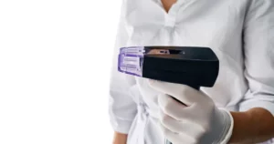 Gloved professional holding a Morpheus8 microneedling device for skin tightening in Mississauga